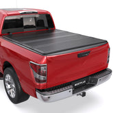 Nissan Titan Red pickup truck equipped with a MOSTPLUS FRP hard quad-fold tonneau cover fully closed over the bed
