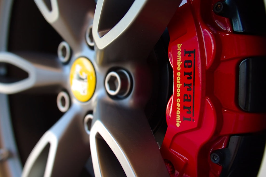 What causes a brake caliper to stick?