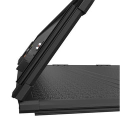 Quad-fold fibreglass truck bed tonneau cover for 04-15 Nissan Titan partially open, showcasing the panel texture, hinge structure, and edge sealing design.